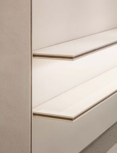 two empty white shelves sitting next to each other