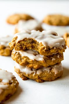 several cookies with white icing stacked on top of each other