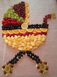 an image of a baby carriage made out of fruit