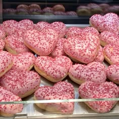 a display case filled with lots of heart shaped doughnuts