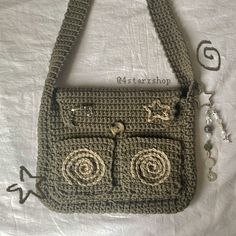 a crocheted purse with two eyes on it