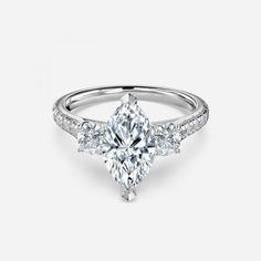 Stone Type: MoissaniteShape: Marquise Clarity: VVS1Color: Colorless (DEF)Cut: ExcellentStyle: Three StoneSKU: UMDMQ-66 Marquise Engagement Ring, Three Stone Engagement, Three Stone Engagement Rings, Three Stone, Moissanite Engagement Ring, Moissanite Engagement, 18k Rose Gold, Timeless Elegance, Engagement Ring