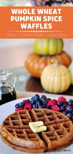 whole wheat pumpkin spice waffles with blueberries and raspberries on the side