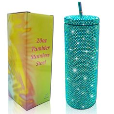 a box with a toothbrush in it next to a tumbler that has sparkles on it