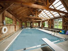 an indoor swimming pool in a wooden building