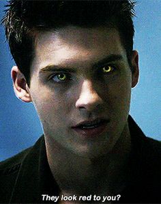 a young man with green eyes looking at the camera and saying, they look red to you?