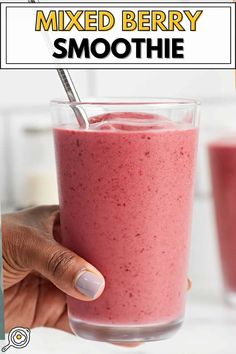 a hand holding a glass with a smoothie in it and the text mixed berry smoothie