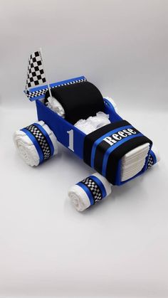 a paper car made to look like a race car with checkered flags on it