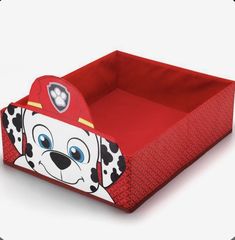 a red toy box with a cartoon dog on it's side and a fireman hat on top