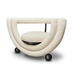 an unusual chair with wheels and a cushion on it's backrest, designed by person