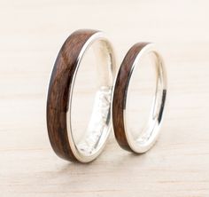 two wedding rings with wooden inlays on them