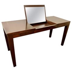 a wooden desk with a mirror on it