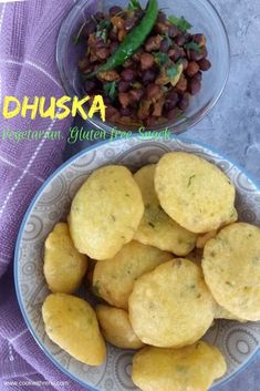 some food is in a bowl and on a purple towel next to a bowl of beans