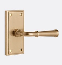 an antique brass door handle on a white background