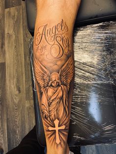 Tattoo cross angel sky Mens Fore Arm Tattoo, Cross Angel Tattoo, 4 Angels Tattoo, Angel Leg Tattoo Men, Angelic Tattoos Men, Angel Forearm Tattoo Men, Angel Tattoo On Forearm, Legs Tattoo Men Ideas Design, Angel Tattoo Forearm