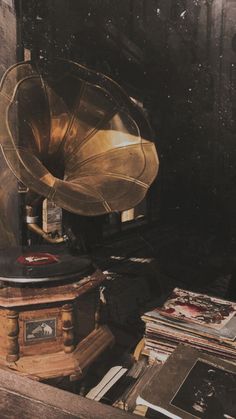 an old record player sitting on top of a wooden table