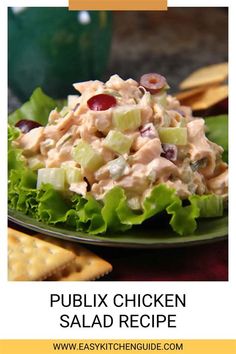 a green plate topped with salad next to crackers