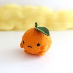 an orange with a green leaf on it's head