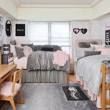 a bedroom with two beds, a desk and some pictures on the wall above them