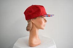 "Vintage 1980s/90s red ball cap with a patterned brim. Made by San Sun. Cotton canvas, with a back plastic adjustable band. The brim is 2.5\" wide at the center front, the crown is 6\" from the edge to the center, and the interior circumference is 20.5 - 22.25\". In good condition, with no holes or stains. The interior sweatband is dingy.  ---> If you need an order shipped by a particular date or shipped via a quicker method, please ask PRIOR to purchase to see if we can accommodate that request Retro Red 5-panel Hat, Red Retro 5-panel Hat, Retro Red Trucker Hat, Retro Red Snapback Hat With Curved Brim, Red Snapback Visor Hat For Summer, Retro Red Snapback Cap, Red Retro Snapback Hat, Retro Red 5-panel Baseball Cap, Vintage Adjustable Visor Snapback Hat