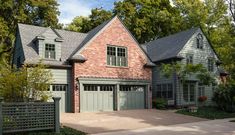 a large brick house with two car garages