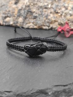 new in shop.  Handmade  adjustable protection bracelet  for everyone, with natural raw black obsidian, knotted with nylon cord.   Bracelet closed length : * 6in (15,4cm)  *  7in(18cm)   * 8in(20cm)     ✧ Please note that no two crystals are alike, therefore shape and size may vary slightly  crystal in length 1,4-1,7cm.  ✧ Each crystal chosen with care and handled with loving intention    ✧ Hand selected natural raw gemstones.  The black obsidian healing properties that are most prominent are its Bohemian Style Black Braided Bracelets As Gift, Adjustable Obsidian Bracelet Jewelry, Adjustable Obsidian Bracelet With Natural Stones, Black Spiritual Friendship Bracelets Adjustable, Black Hand Wrapped Spiritual Friendship Bracelets, Black Bohemian Braided Bracelets Hand Wrapped, Black Bohemian Bracelets With Adjustable Cord, Gift Black Braided Bracelets With Adjustable Cord, Adjustable Spiritual Obsidian Jewelry