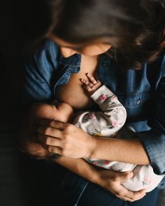 a woman holding a baby in her arms