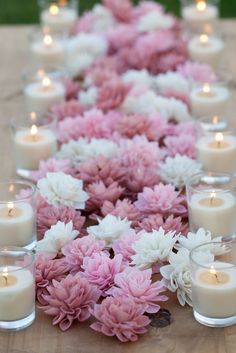 a long table with candles and flowers on it