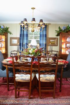 a dining room table with chairs and a chandelier