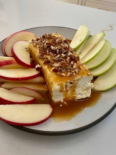 a plate with apples and cheese covered in caramel sauce