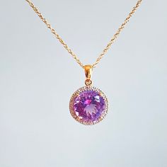 Beautiful amethyst and diamond pendant presented on in 14k gold chain. The amethyst has the most beautiful, crystal clear, watery purple color. A halo setting balances its delicate look with sparkling white diamonds. It's really lovely, and would make a wonderful gift for any special woman in your life - Mother, Daughter, Wife, etc. Approximate dimensions: Amethyst is ~10 mm diameter. Total necklace weight is 3.1 grams. Photos are an important part of item description so please review carefully. Fine Jewelry Purple Diamond Necklace, Purple Diamond Necklace Fine Jewelry, Purple Diamond Necklace With Diamond Accents, Purple Diamond Necklace In Fine Jewelry Style, Gold Amethyst Jewelry With Halo Setting, Purple Diamond Birthstone Necklace, Yellow Gold Amethyst Jewelry With Halo Setting, Purple Amethyst Necklace With Diamond Accents, Purple Diamond Round Necklace