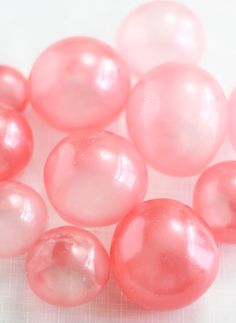 some pink bubbles on a white surface