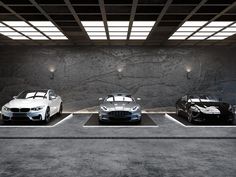 three cars parked in front of a stone wall