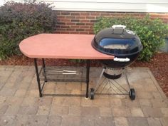 an outdoor bbq table with a grill on it