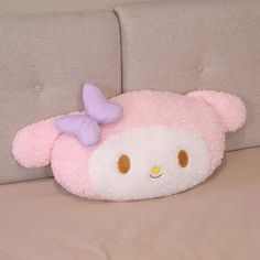 a hello kitty pillow sitting on top of a bed