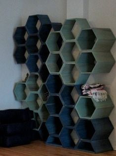 the shelves are made out of hexagonal shapes and stacked on top of each other