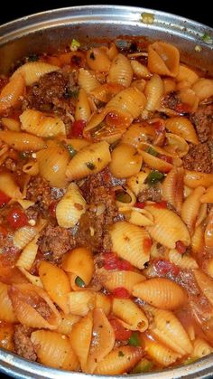 a pot filled with pasta and meat in sauce