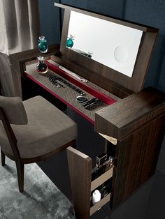 a desk with a chair and a mirror on it