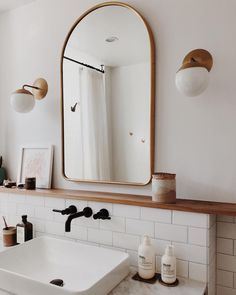 a bathroom sink with a mirror above it