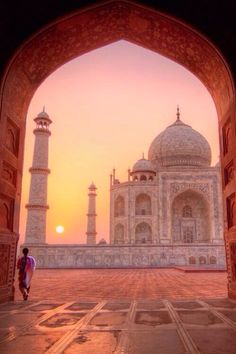 an archway leading to the tajwa mosque at sunset