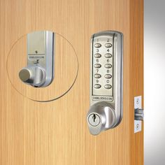 an electronic door lock on a wooden door with a circular hole in the middle that is open