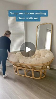 a woman standing in front of a couch with a mirror on it's side