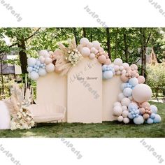 an outdoor wedding ceremony with balloons and flowers on the back wall, decorated in pastel colors