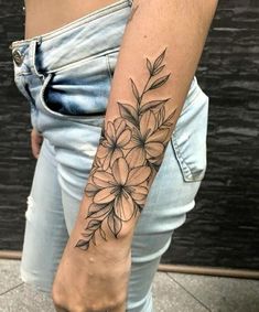 a woman's arm with a flower tattoo on the left side of her arm