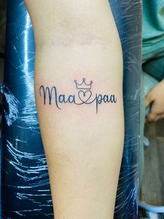 a person with a tattoo on their arm that says maa and pau in black ink