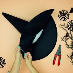 someone is making a witches hat out of felt