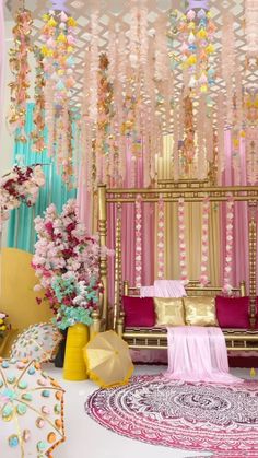 an elaborately decorated stage with pink and gold decorations on the walls, hanging from ceiling