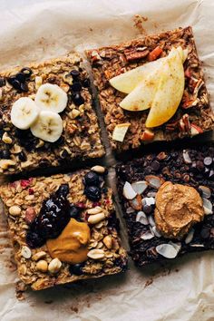 four granola bars topped with fruit and nuts