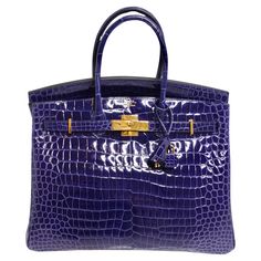 Introducing the epitome of luxury and sophistication, the Hermes Birkin 35cm Amethyst Shiny Porosus Crocodile Gold Hardware handbag. Crafted in 2020, this iconic handbag is a testament to Hermes' impeccable craftsmanship and timeless design. This stunning Birkin handbag features the rare and coveted Amethyst shade in luxurious shiny Porosus crocodile leather, exuding elegance and opulence. The deep purple hue adds a touch of sophistication to any ensemble, making it a versatile statement piece for any occasion. The gold hardware accents beautifully complement the rich color of the crocodile leather, elevating the bag's allure and adding a touch of glamour. The Birkin 35 size offers ample space for all your essentials, making it both practical and stylish. As one of the most iconic and soug Purple Birkin, Birkin Bag Price, Croc Birkin, Cartier Earrings, Statement Handbag, Birkin Handbags, Hermes Birkin 35, Nike Fashion Shoes, Favorite Handbags