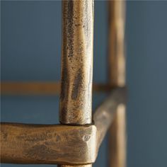 a close up view of a wooden chair with metal bars on the armrests